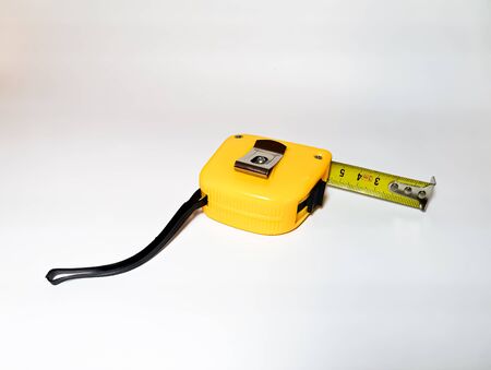 Yellow tape measure on a white background. Metric measurement system.の写真素材