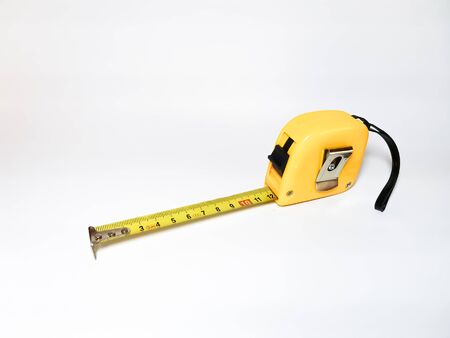 Yellow tape measure on a white background. Metric measurement system.の写真素材