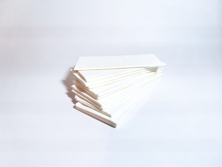 A stack of paper handkerchiefs (tissues) on a white background. Hygienic tissues for disposable...