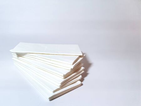A stack of paper handkerchiefs (tissues) on a white background. Hygienic tissues for disposable usage.の写真素材