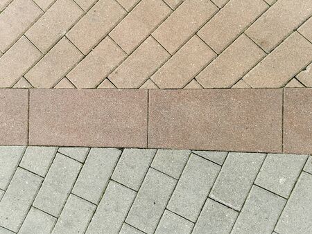 Unevenly laid paving slabs in three colors. View from above. Tile laying illustration. City plot. Abstract geometric texture.の写真素材