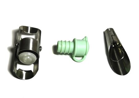 Three types of bottle stoppers: silicone, metal for wine and metal for champagne. Isolated over white background.の写真素材