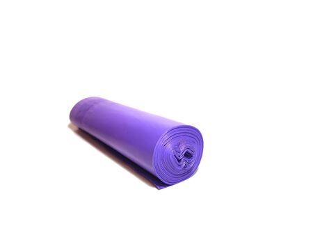 Close-up of a roll of purple polyethylene garbage bags on a white background. Household accessories. Perspective in perspective.の写真素材