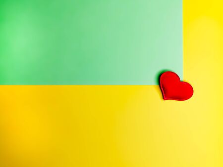 Template in yellow-green color and red heart for a greeting or invitation card. A place for your imagination and creativity. Symbol of relationships, love, romance.の写真素材