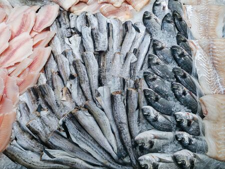 Fresh fish counter at the market. Beautifully laid out on ice fresh dorado, gutted pollock and cod fillet. Natural products, proper nutrition, fish diet.の写真素材