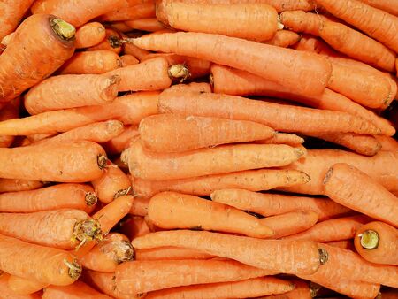 Solid background of last year's dirty carrots in the market. Popular and affordable vegetables in the supermarket. Ð¡arrots is a source of Vitamin A. Top view.の写真素材