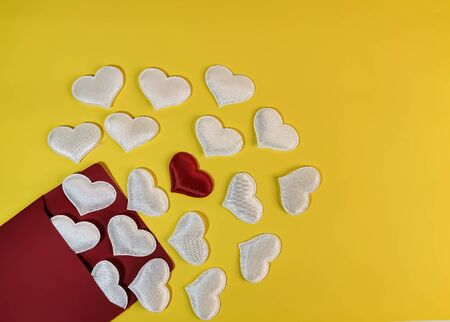 White hearts fly out of a red envelope and in the center is one red heart on a yellow background. Symbol of romantic declaration of love, marriage proposal, love letter. Blank for design, text space, template.の写真素材