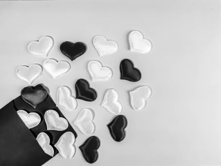Black and white image from the envelope fly out hearts of different colors. Symbol of romantic declaration of love, marriage proposal, love letter. Blank for design, text space, template.の写真素材
