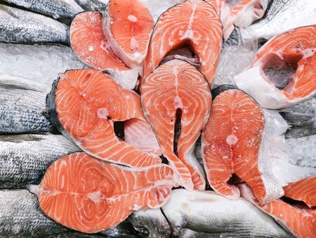 Fresh fish counter in the market. Laid out on ice salmon steaks. Natural products, proper nutrition, fish diet, local food. Beautiful decoration of the fish counter.の写真素材