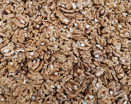 Peeled ripe walnuts on the counter of a farmers market. Background of nuts. Healthy nutrition and vitamins. Selective focusの写真素材
