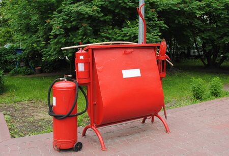The fire set installed at a gas station. It consists of fire extinguishers, a box sand, a shovel for elimination of fire. A gas station is a place where security measures must be at the highest levelの写真素材