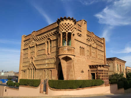 Colonia Guell/Spain - 11.24.2017: One of the old red brick mansions in the Guell Colony on a clear sunny day against a blue sky. A sample of the architect of Spain in the early twentieth century.のeditorial素材