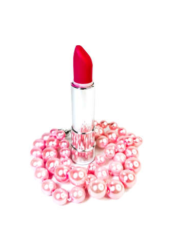 Bright pink open lipstick in a silver case and pink pearl beads isolated on a white background. Makeup concept, beauty industry. Place for text and logo.の写真素材