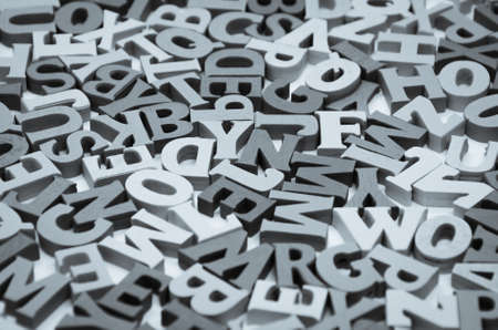 Abstract black and white background of wooden letters of the Latin alphabet. Concept: back to school, literacy and reading, language learning. Selective focusの写真素材