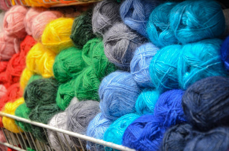 Counter in shop for knitting and needlework with coils colored wool yarn. Different bright colors...