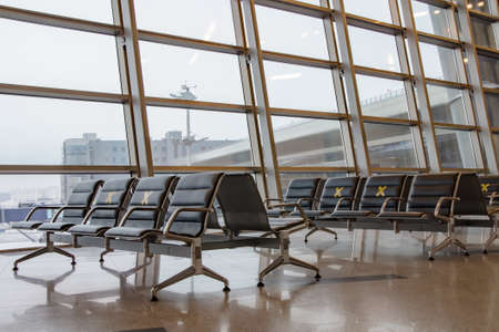 Moscow, Russia: 03.15.2021 - Vnukovo International Airport, departure area. Labeled waiting chairs for social distancing during a pandemic.のeditorial素材