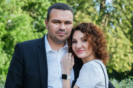 Portrait of a couple in love. A Middle Eastern man in a business suit with his curly-haired wife....