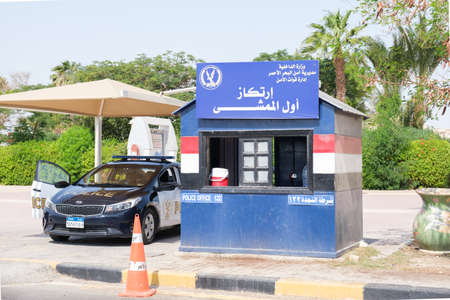Police checkpoint on the city road in the tourist part of Hurghada. Egyptian police are checking passing cars. Security measures at the resort. Hurghada, Egypt - 10.13.2021のeditorial素材