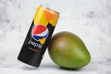 Can of pepsi drink with mango flavor and mango fruit. Expanding the range of PepsiCo products. Pepsi...