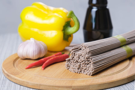 Dry Soba buckwheat noodles and ingredients for preparing an Asian dish. Spices and assorted...