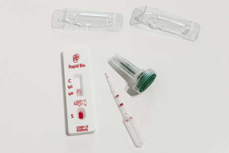 Used rapid test for SARS-COV-2 coronavirus antigen of Rapid Bio. Test cartridge with drop of blood, dropper bottles with buffer solution, microcentrifuge tube and pipette. Moscow, Russia - 11.25.2021のeditorial素材