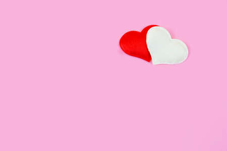 Minimalistic pink background with two hearts in the upper corner. Template on the theme of valentine's day, romantic letterhead for cards, invitations, copy spaceの写真素材