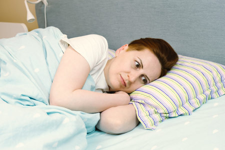 Woman tries to fall asleep and cannot because of headaches, stress and depression. The woman is...