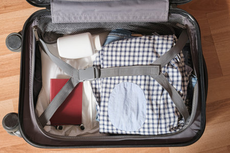 Things folded in a suitcase for hand luggage on a business trip - clothes, medicines, passport....