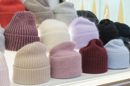 Showcase of trade tent with variety of women's hats for the autumn and winter seasons - knitted...