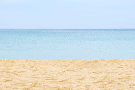 Calm seascape in pastel colors. Beach with sandy yellow sand, calm sea and blue sky without clouds....