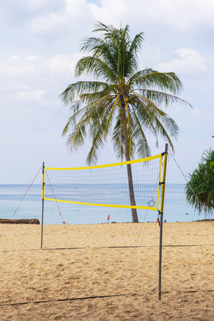 Empty volleyball court for beach volleyball on a sandy beach by the sea. Stretched volleyball net for playing on the sandy beach.の写真素材