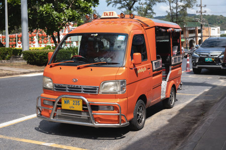 Parked red hijet pickup truck converted to carry passengers in the back. Tuk-tuk in the resort area of Phuket, Thailand. Phuket, Thailand - 24.01.2023のeditorial素材