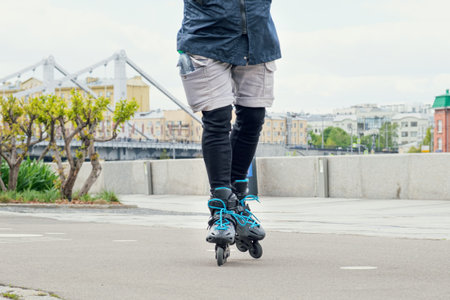 Man in shorts and leggings on roller skates. Occupation by amateur sports on the city embankment.の写真素材