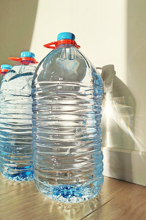 Plastic bottles with drinking water on a monochrome background. Bottled drinking water in raw