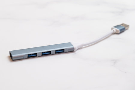 Port Multi Splitter Adapter USB hub for connecting additional equipment to a computer or laptop. Additional USB ports in a metal case on a short wire.の写真素材