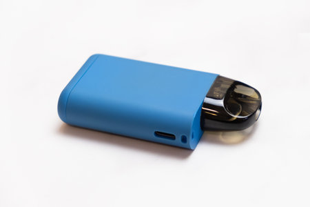 POD-system for smoking on a light background. A device with a replaceable cartridge for nicotine liquid. An electronic cigarette for smoking.の写真素材