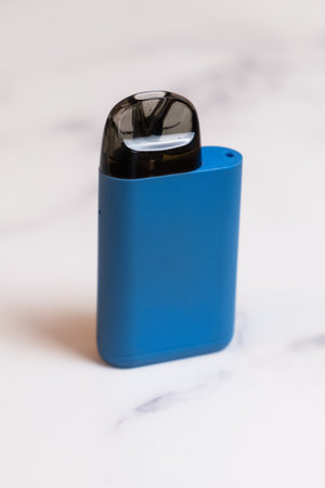 POD-system for smoking on a light background. A device with a replaceable cartridge for nicotine liquid. An electronic cigarette for smoking.の写真素材