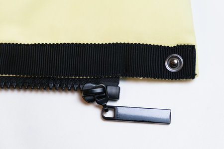 Close-up of the black plastic zipper on the outerwear. Accessories for making clothes, textiles. Concept of haberdashery.の写真素材