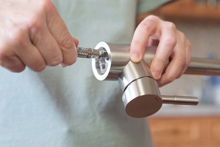 A close-up of a mixer with flexible hoses for cold and hot water installed. Preparing to replace the kitchen faucet.の写真素材