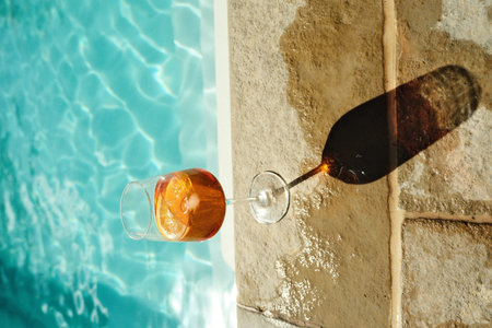 Refreshing cocktail beside a sunlit pool on a warm afternoon