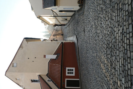 Charming cobblestone street winding through historic architecture in a quiet neighborhood during early morning lightの写真素材