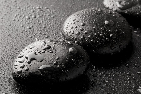 zen basalt stones with dew on blackの写真素材