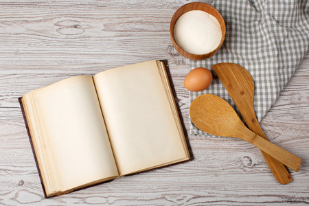 Cooking concept  Ingredients and kitchen tools with the old blank recipe bookの写真素材
