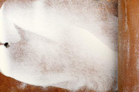 white flour on wooden table の写真素材