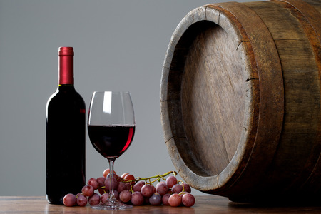 Wine with barrel on wooden tableの写真素材