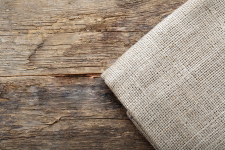 folded tablecloth on wooden tableの写真素材