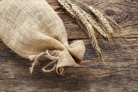 rye with a linen bag on wooden backgroundの写真素材