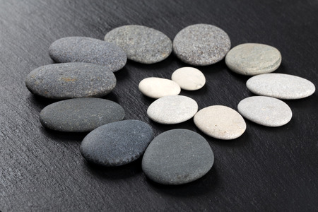 Black and white stones on rock backgroundの写真素材