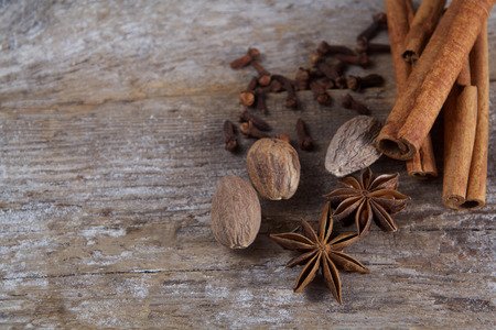 Spices on wooden background. Cinnamon, nutmeg, cloves, aniseの写真素材