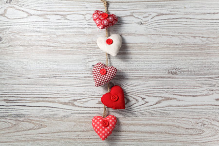 Heart-shaped decoration on wooden background